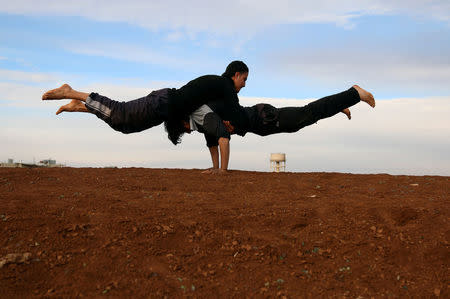 Parkour coach Ibrahim al-Kadiri, 19, and Muhannad al-Kadiri (top), 18, demonstrate their parkour skills in the rebel-held city of Inkhil, west of Deraa, Syria, February 4, 2017. "I love competing with my friends to achieve the highest jump," Muhannad says. REUTERS/Alaa Al-Faqir