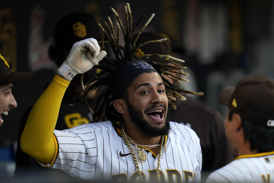 San Diego Padres' Fernando Tatis Jr. reacts in the dugout after hitting a home run during the first inning of a baseball game against the Arizona Diamondbacks, Friday, June 25, 2021, in San Diego. (AP Photo/Gregory Bull)