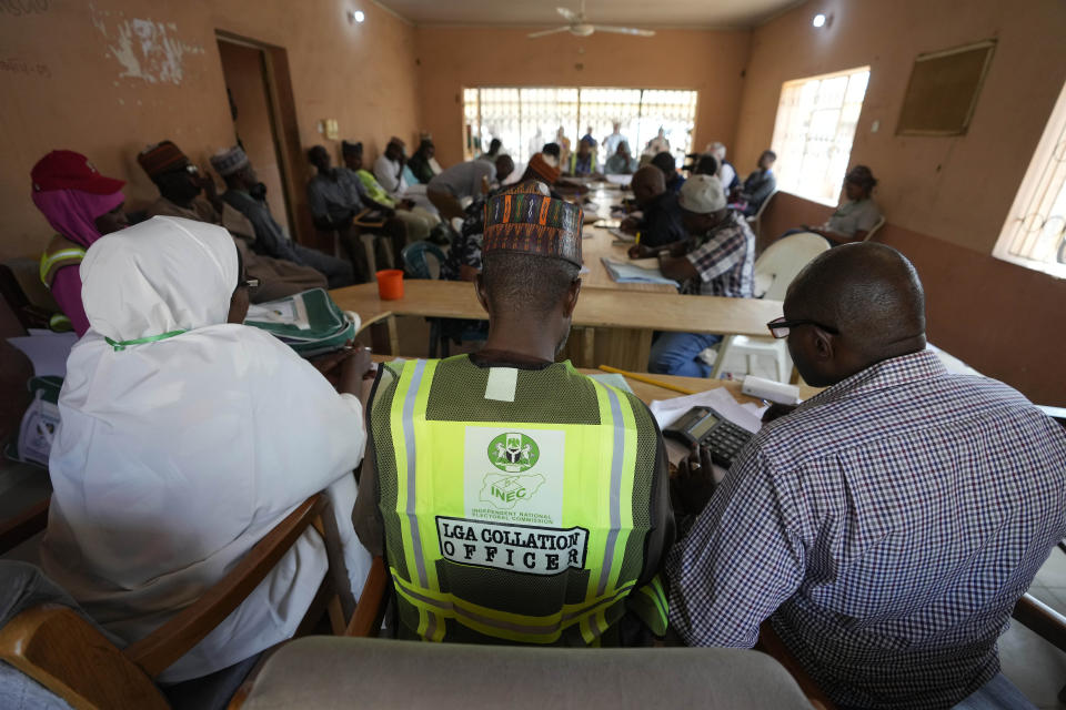 Electoral officials check election documents, at the Local Independent National Electoral Commission office in Yola, Nigeria Sunday, Feb. 26, 2023. People are still voting across Nigeria, one day after Africa's most populous nation went to the polls to vote for presidential and parliamentary elections. Votes are being cast in Benue, Adamawa and Bayelsa states, while ballots are being tallied in places where voting is complete, with preliminary results expected as early as Sunday evening. (AP Photo/Sunday Alamba)