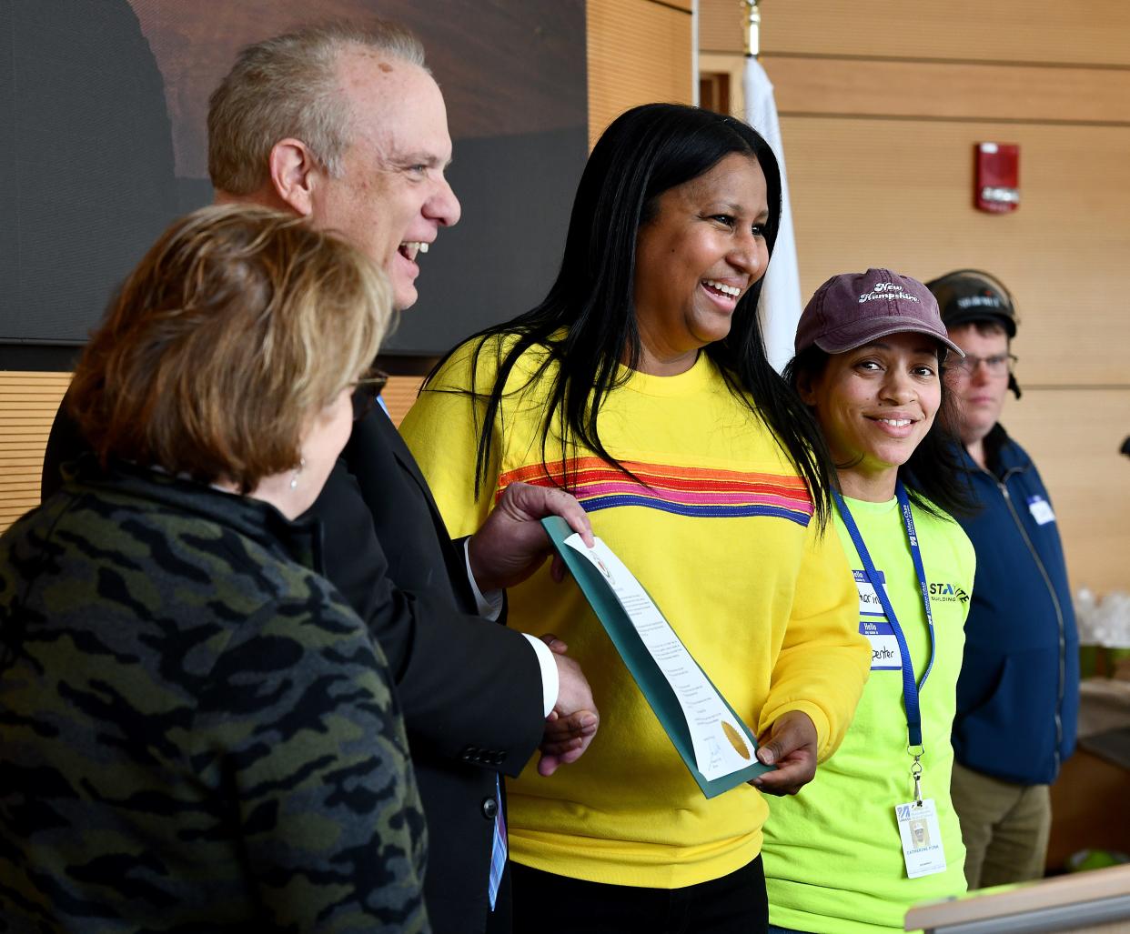 Charran Fisher, center, CEO at Fisher Contracting Corporation, is presented with a proclamation by Worcester Mayor Joseph Petty at a Women in Construction conference Friday at UMass Chan Medical School.