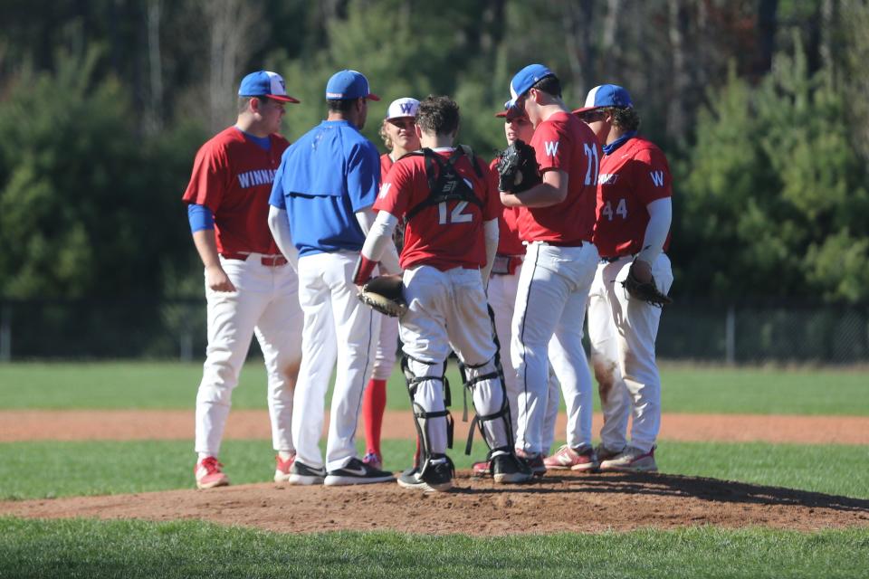 Winnacunnet High School baseball head coach Aaron Abood speaks to his team at the mound during Friday's 4-3 loss to Exeter.