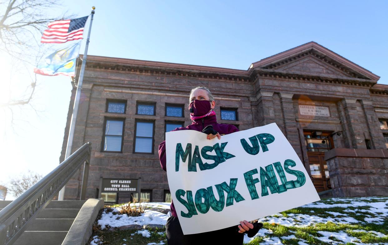 <p>Jenae Ruesink holds a sign demanding a mask mandate from city council on Monday, Nov. 16, 2020 outside Carnegie Town Hall in Sioux Falls, S.D. (Erin Bormett/The Argus Leader via AP)</p> (USA TODAY NETWORK)