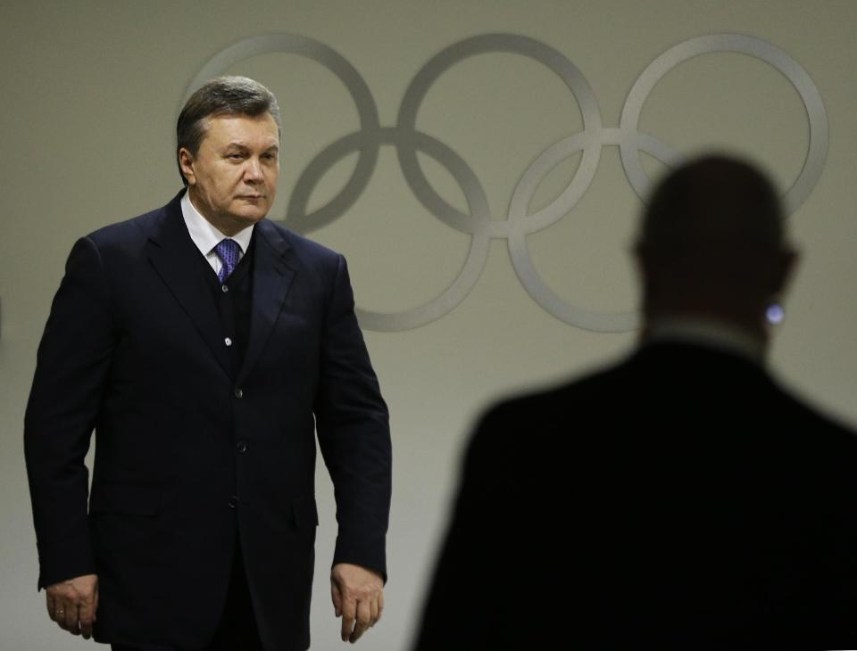 Ukrainian President Viktor Yanukovych walks through the presidential lounge to take his seat at the opening ceremony of the 2014 Winter Olympics, Friday, Feb. 7, 2014, in Sochi, Russia. (AP Photo/David Goldman, Pool)