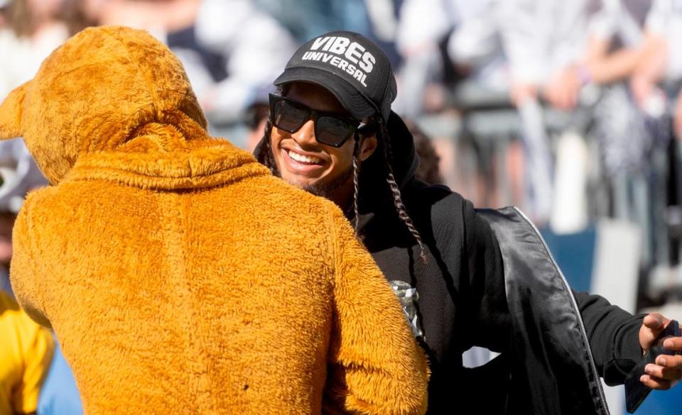 Former Penn State player and current Pittsburgh Steeler Marcus Allen hugs the Nittany Lion during the Penn State football game against Central Michigan on Saturday, Sept. 24, 2022.