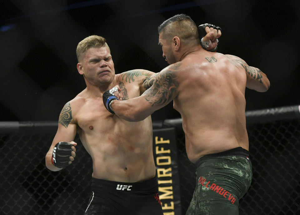 May 13, 2020; Jacksonville, Florida, USA; Chase Sherman (red gloves) fights Ike Villanueva (blue gloves) during UFC Fight Night at VyStar Veterans Memorial Arena. Mandatory Credit: Jasen Vinlove-USA TODAY Sports