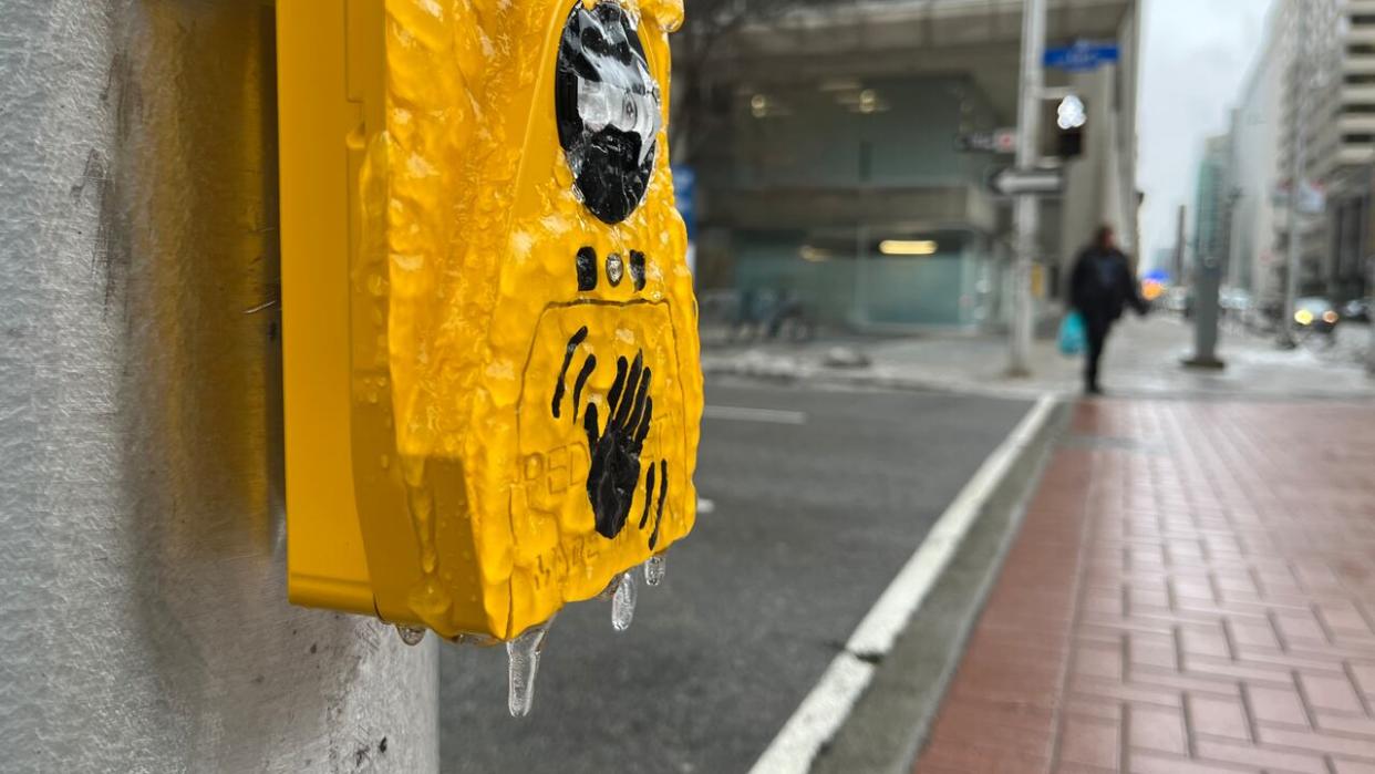 Ice coats a crosswalk sensor in Ottawa on Jan. 5, 2023. Environment Canada issued freezing rain warnings for the region on Wednesday and again on Thursday. (Matthew Kupfer/CBC - image credit)