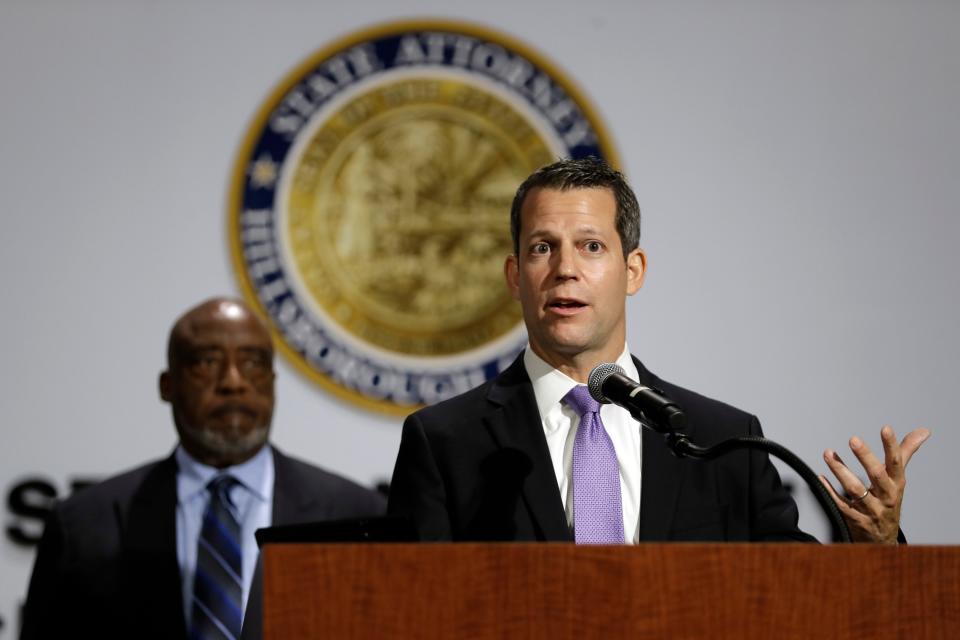 Hillsborough County State Attorney Andrew Warren, right, speaks during a news conference in 2020 in Tampa, Fla. Warren announced his decision not to prosecute dozens of protesters arrested on charges of unlawful assembly during a Black Lives Matter march on June 2. Looking on is Bishop Thomas Scott.