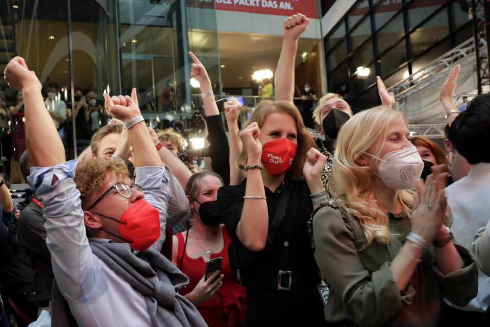 Supporters react after German parliament election at the Social Democratic Party, SPD, headquarters in Berlin, Sunday, Sept. 26, 2021. (AP Photo/Lisa Leutner)