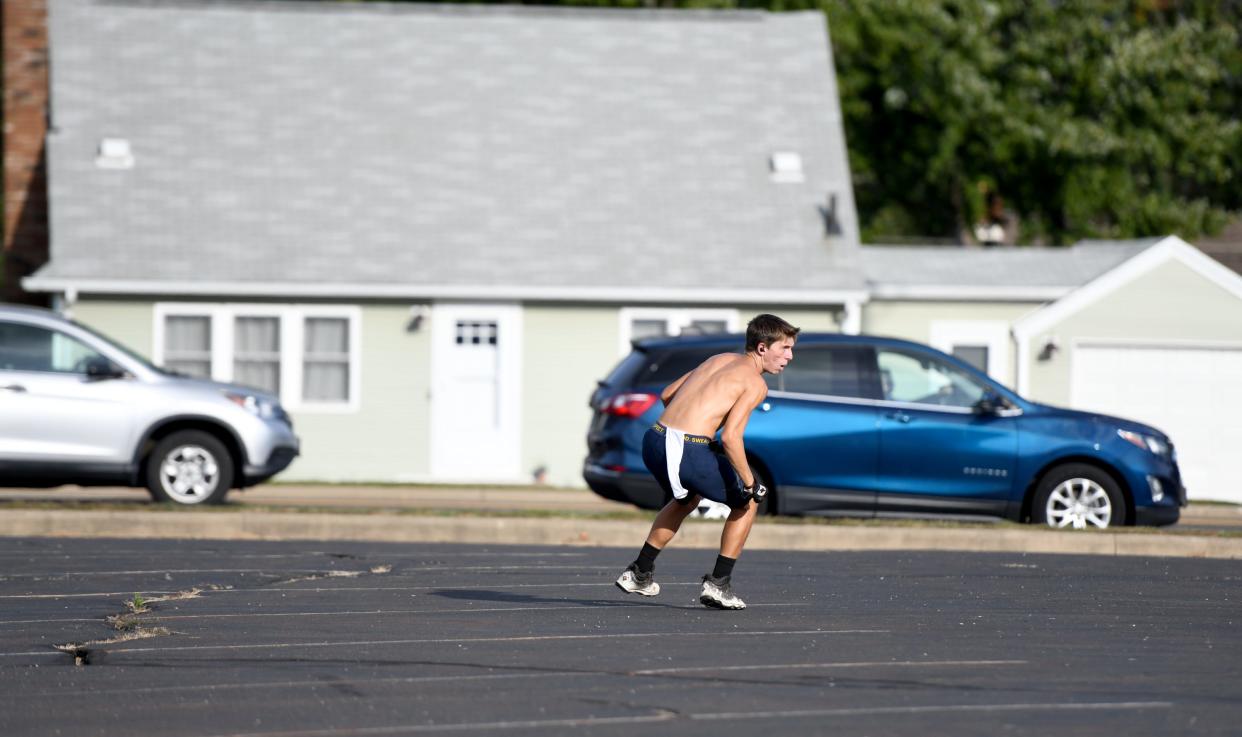 Joseph Jones, McKinley freshman football player, practices running routes by himself in the Canton Baptist Temple parking lot.