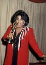 <p>Take a tip from Oprah, and match your eyeshadow with your 'fit. Here, she donned a blazer with sequin detailing at the shoulders over a black V-neck dress. She picked up her award this year for Outstanding Talk Show Host. </p>