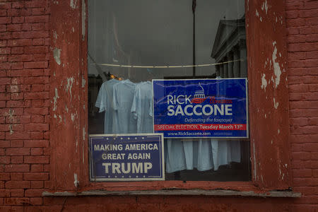 A window announcing support for Congressional candidate Rick Saccone is seen on High Street in Waynesburg, Pennsylvania, U.S., February 14, 2018. Picture taken February 14, 2018. REUTERS/Maranie Staab