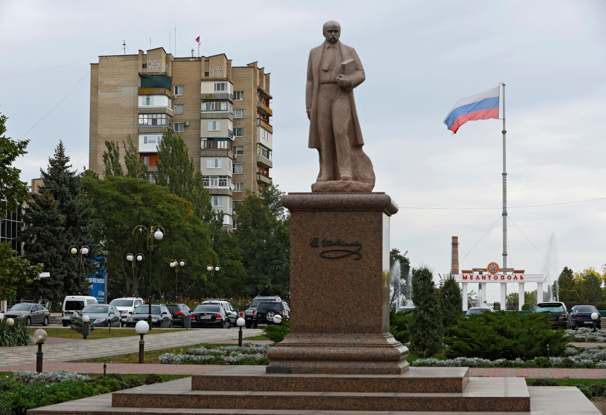 A view shows a monument to Ukrainian poet Taras Shevchenko with the Russian flag flying in the background during a five-day referendum on the secession of Zaporizhzhia region from Ukraine