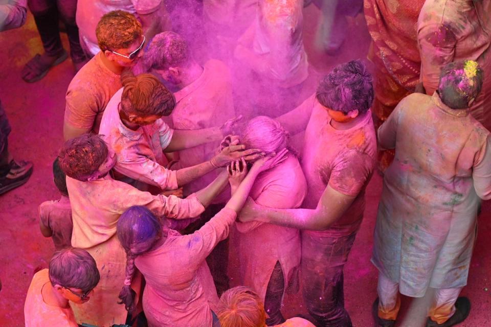 People smeared with ‘Gulal’ as they celebrate Holi, the Hindu spring festival of colours, in Hyderabad (AFP via Getty Images)