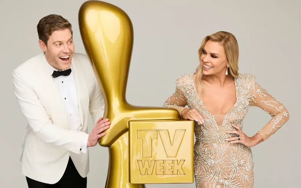 Chris Brown and Sonia Kruger posing next to a Gold Logie.