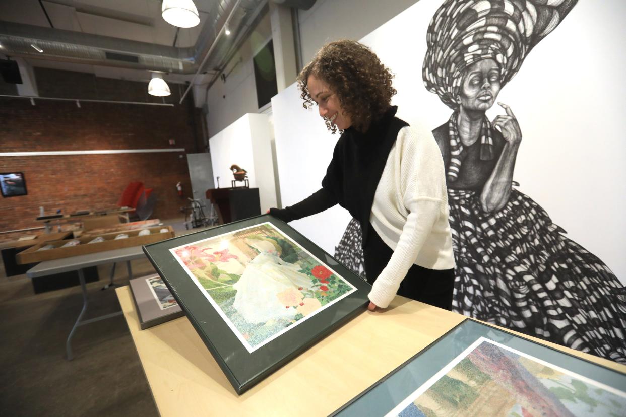 Art Effect executive director, Nicole Fenichel-Hewitt, looks over artwork that will be installed for the next show at the Trolley Barn in the City of Poughkeepsie on December 6, 2023.