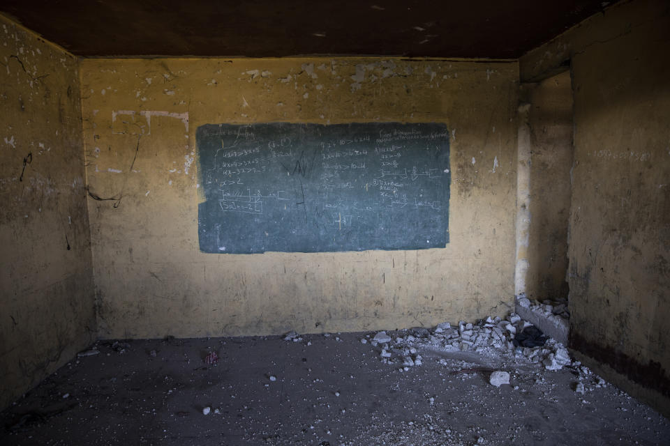 Algebraic equations cover a painted green rectangle serving as a chalkboard in an abandoned classroom in Fort Dimanche, once a prison where the late Haitian dictator Francois "Papa Doc" Duvalier imprisoned his enemies, in Port-au-Prince, Haiti, Thursday, Sept. 23, 2021. (AP Photo/Rodrigo Abd)