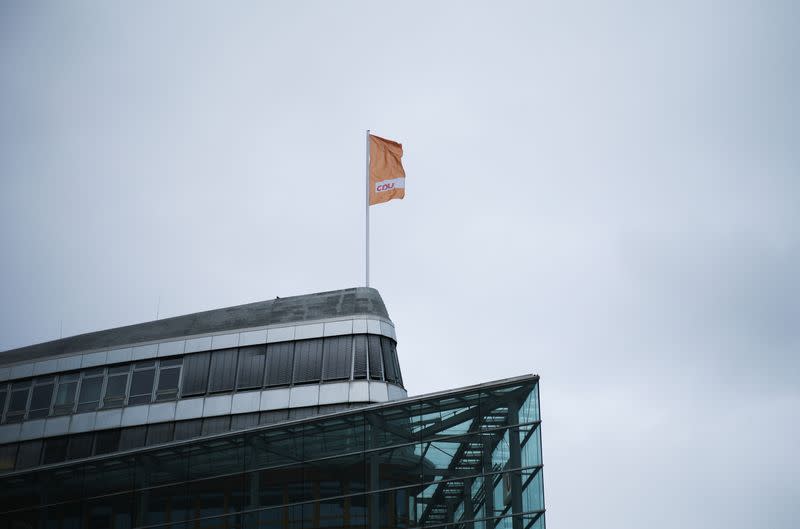 A flag of Germany's Christian Democratic Union party, CDU, the party of Chancellor Angela Merkel, waves in the wind on top of the party's headquarters in Berlin