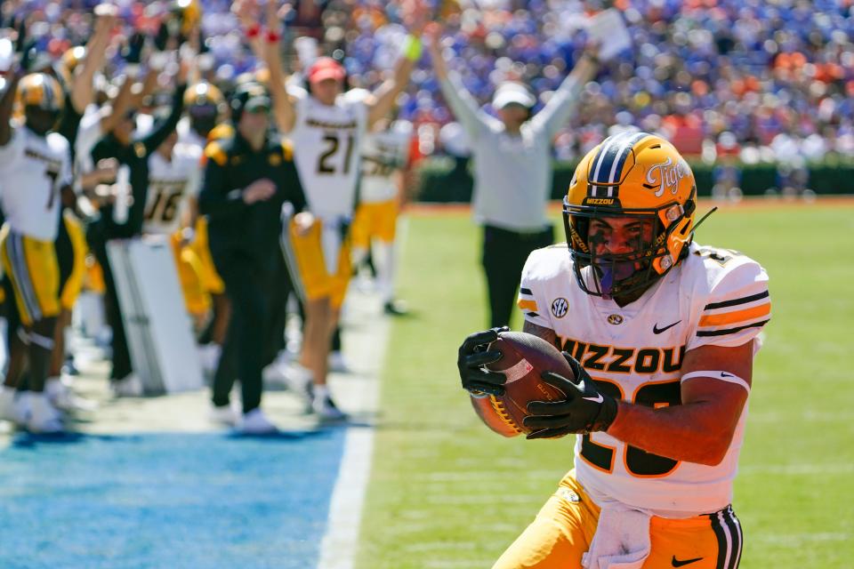 Missouri running back Cody Schrader crosses the goal line on a 5-yard touchdown run against Florida during the first half of an NCAA college football game, Saturday, Oct. 8, 2022, in Gainesville, Fla. (AP Photo/John Raoux)