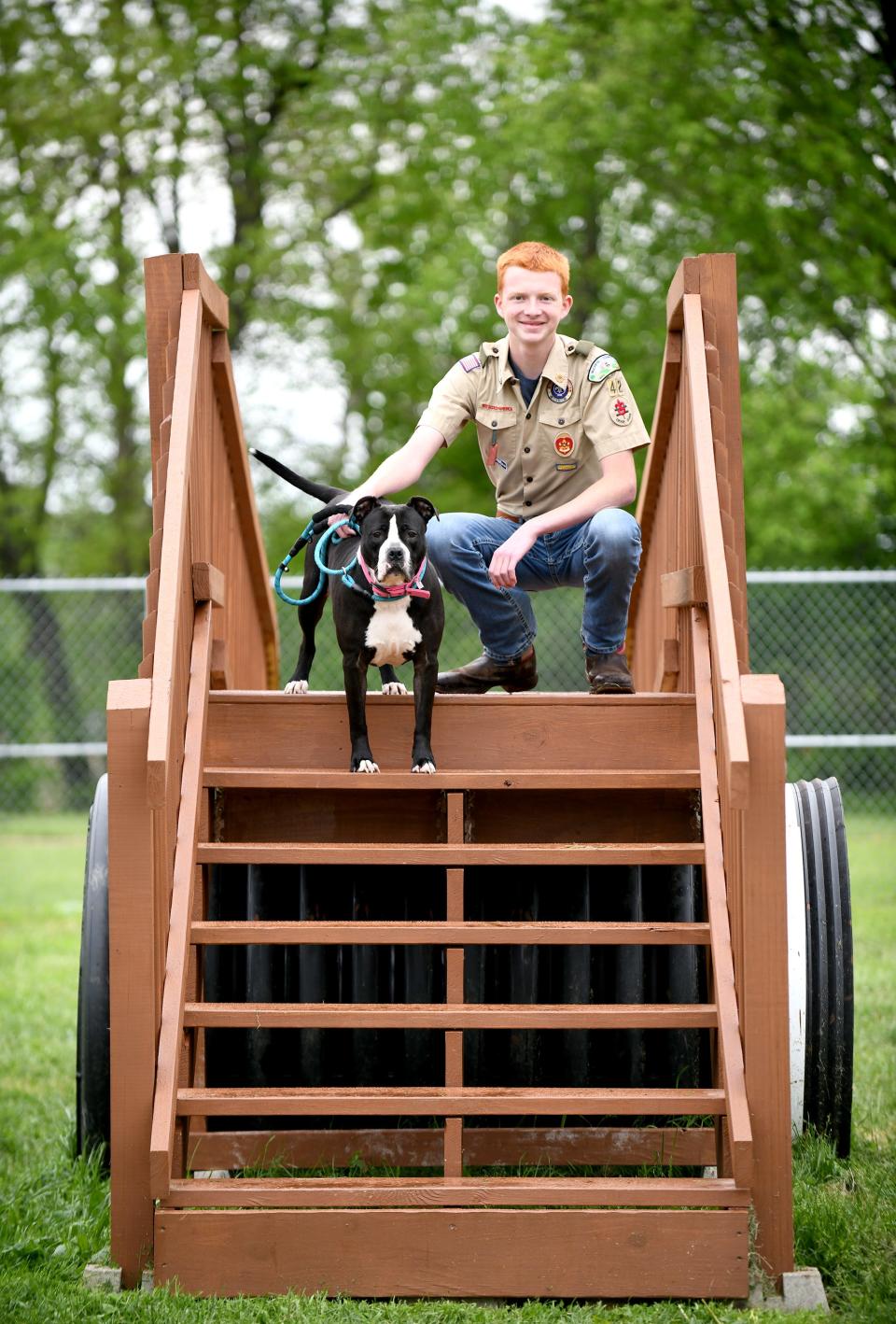 GlenOak sophomore Jacob Price, shown with rescue dog Baby Girl, has spent the last two years planning, designing and building a dog agility course for the Stark County Humane Society for his Eagle Scout project.