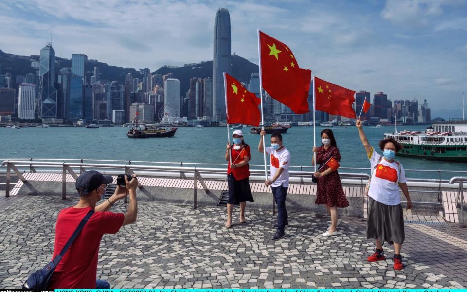 Pro-China supporters display People's Republic of China flags to mark China's National Day in Hong Kong - Billy H.C. Kwok /Getty Images AsiaPac 