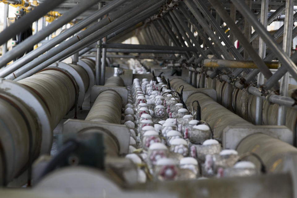 This photo shows a device to freeze dirt to make an underground retention wall to surround nuclear reactors in an attempt to avoid leakage of radioactive water at the Fukushima Daiichi nuclear power plant in Okuma town, Fukushima prefecture, northeastern Japan, Saturday, Feb. 27, 2021. (AP Photo/Hiro Komae)