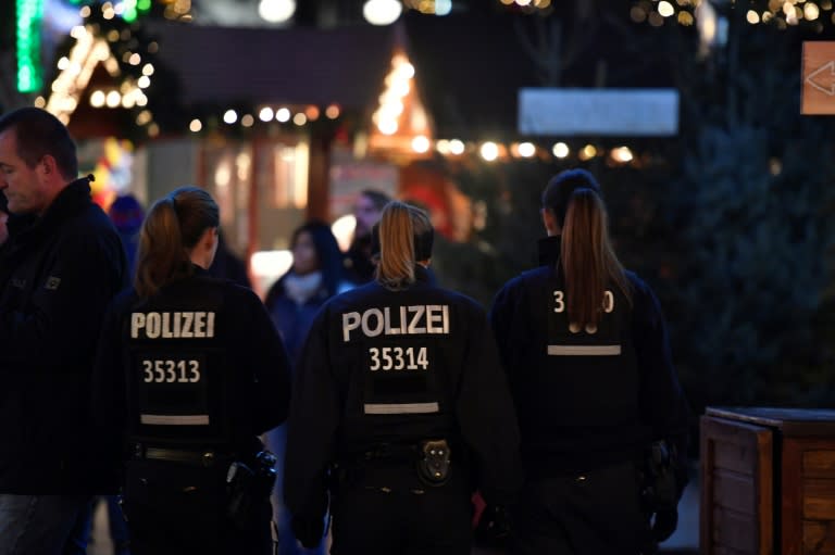 Policewomen patrol the Christmas market at Breitscheidplatz in Berlin a year after the deadly attack