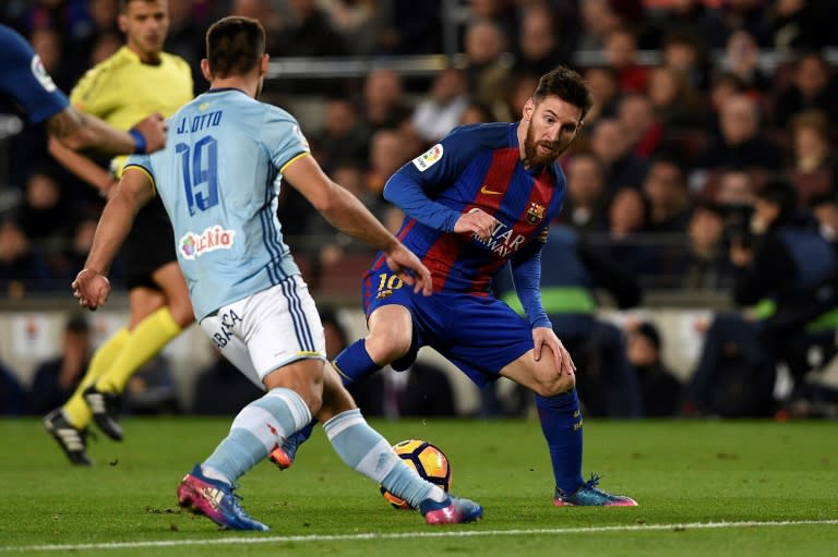 Barcelona's forward Lionel Messi (R) vies with Celta Vigo's defender Jonny Castro during the Spanish league football match FC Barcelona vs RC Celta de Vigo at the Camp Nou stadium in Barcelona on March 4, 2017