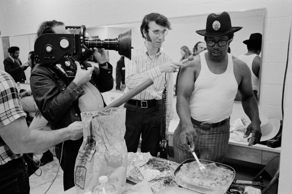 <p>Bo Diddley cooks fried chicken before a concert at Madison Square Garden in 1972, while being interviewed pre-show.</p>