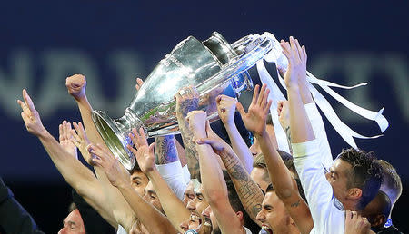 Soccer Football - Champions League Final - Real Madrid v Liverpool - NSC Olympic Stadium, Kiev, Ukraine - May 26, 2018 Real Madrid celebrate winning the Champions League with the trophy REUTERS/Hannah McKay