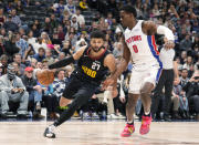 Denver Nuggets guard Jamal Murray (27) drives to the rim as Detroit Pistons center Jalen Duren (0) defends in the first half of an NBA basketball game Sunday, Jan. 7, 2024, in Denver. (AP Photo/David Zalubowski)