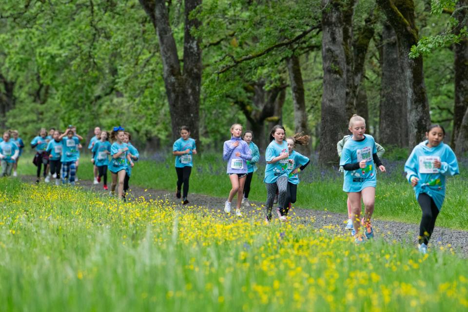 Fourth grade girls run the trails at Bush's Pasture Park during the 2024 Awesome 3000.