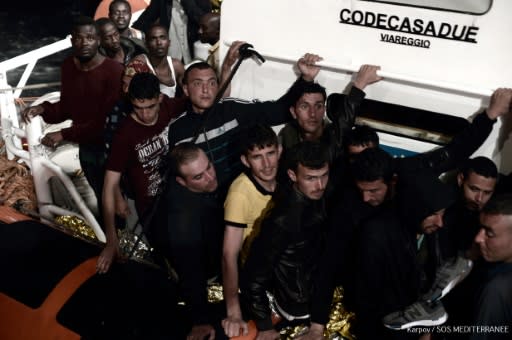 Migrants pictured before boarding the SOS Mediterranee NGO's ship Aquarius in the search and rescue zone in the Mediterranean during the night of June 9, 2018 to June 10