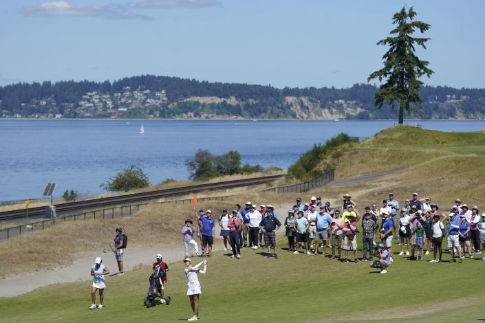 Saki Baba, of Japan, fourth from lower left, hits from the 16th fairway as a growing crowd looks on, Sunday, Aug. 14, 2022, during the final round of the USGA Women's Amateur Golf Championship at Chambers Bay in University Place, Wash. (AP Photo/Ted S. Warren)