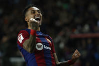 Barcelona's Raphinha celebrates after scoring his side's opening goal during a Spanish La Liga soccer match between Barcelona and Las Palmas at the Olimpic Lluis Companys stadium in Barcelona, Spain, Saturday, March 30, 2024. (AP Photo/Joan Monfort)