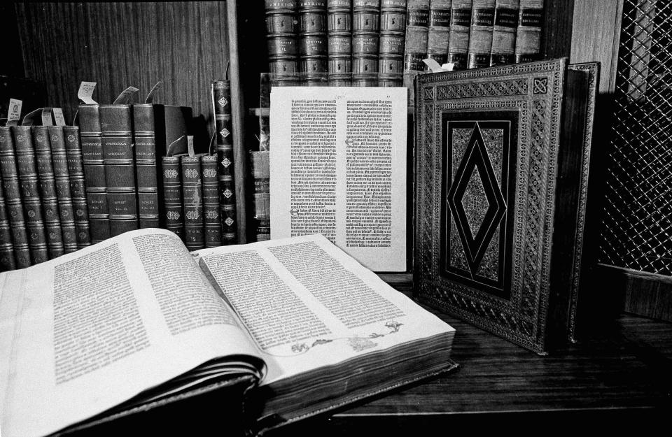 FILE - Two volumes of the over 500-year-old Gutenberg Bible are pictured in New York in April 1978. Johannes Gutenberg planned on printing 150 Bibles, but increasing demand motivated him to produce 30 extra copies, which led to a total of 180. Currently known as the “Gutenberg Bibles”, around 48 complete copies are preserved. (AP Photo/G. Paul Burnett, File)
