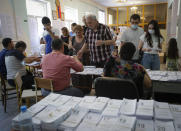 People at a polling station during a parliamentary election in Yerevan, Armenia, Sunday, June 20, 2021. Armenians are voting in a national election after months of tensions over last year's defeat in fighting against Azerbaijan over the separatist region of Nagorno-Karabakh. (AP Photo/Sergei Grits)