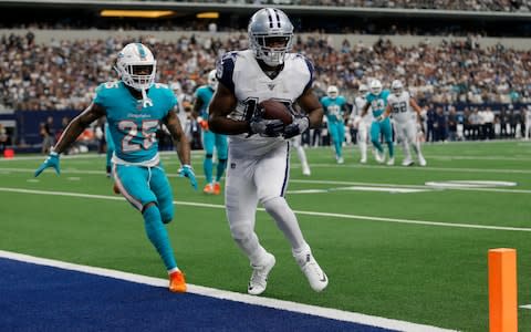 Dallas Cowboys wide receiver Amari Cooper (19) catches a pass for a touchdown as Miami Dolphins cornerback Xavien Howard (25) defends in the first half of a NFL football game in Arlington, Texas - Credit: AP