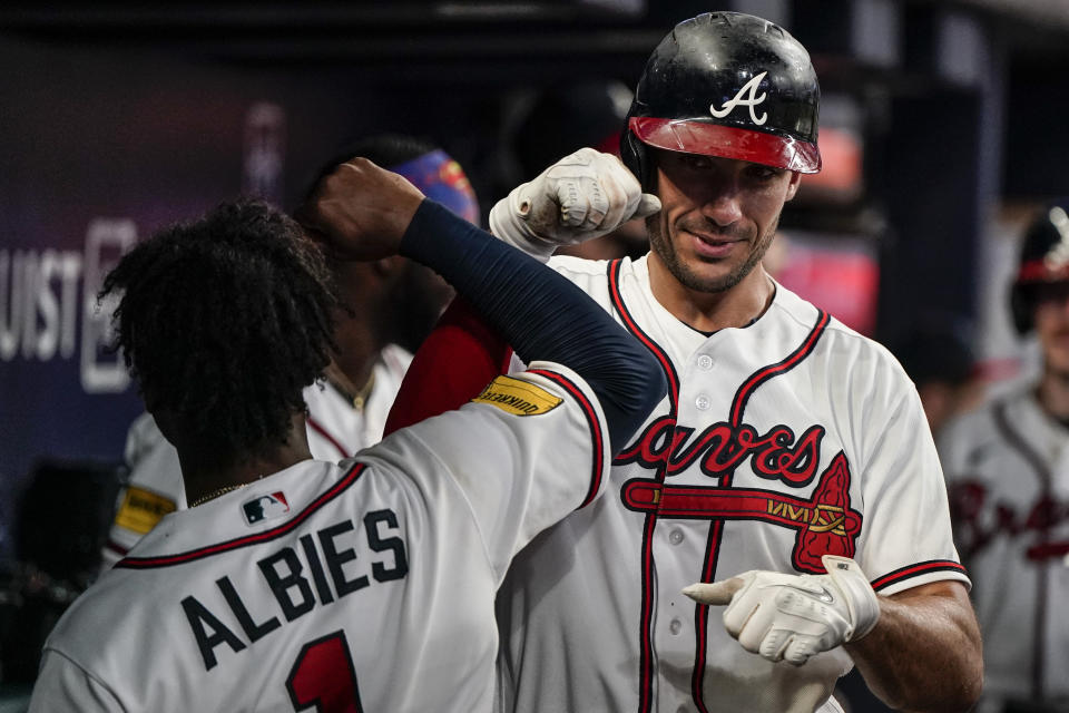 Atlanta Braves first baseman Matt Olson, right, celebrates his solo home run in the dugout during the sixth inning of a baseball game against the St. Louis Cardinals, Wednesday, Sept. 6, 2023, in Atlanta. (AP Photo/Mike Stewart)