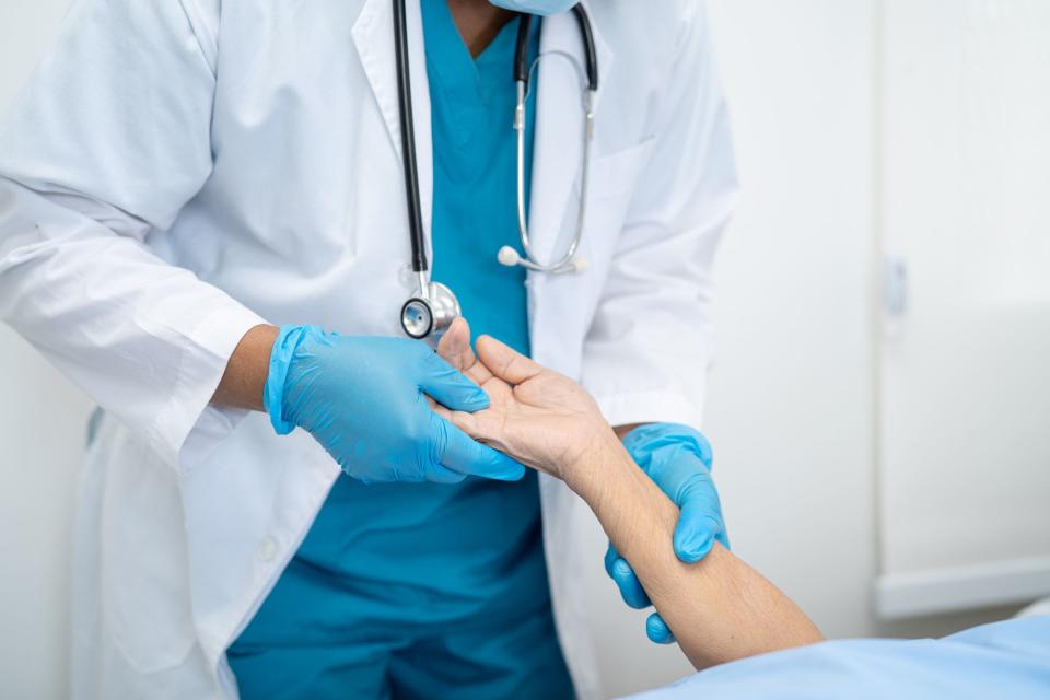 <p>Getty</p> Stock image of a doctor holding patient