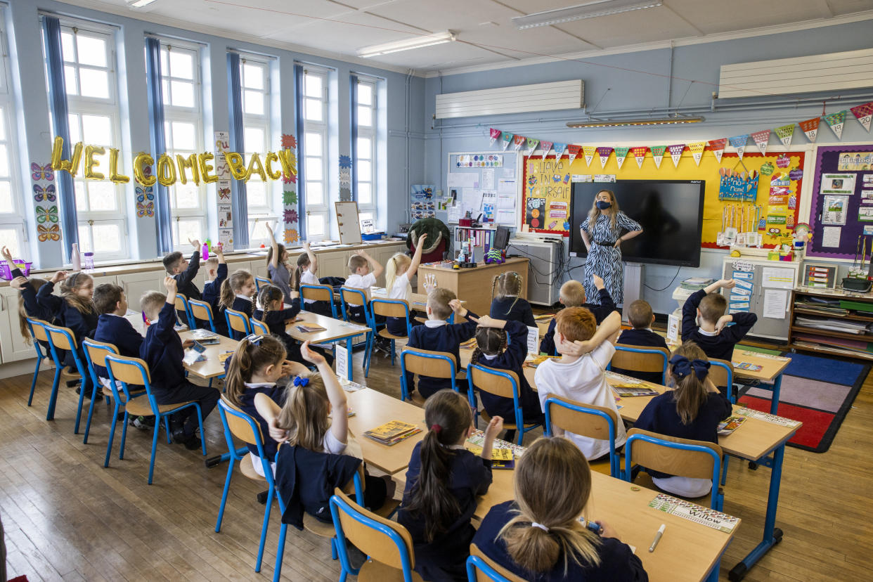 P3 teacher Jessica Cargill with her class at Springfield Primary School in Belfast. Today marks the first day back for Pre-school, nursery and primary school pupils in P1-P3 have retruned to classrooms across Northern Ireland. Picture date: Monday March 8, 2021.