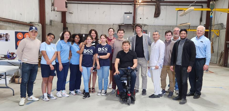 Kyrgyzstani delegates and members of the New Bedford Research & Robotics community stand together for a group photo on Wednesday, Oct. 4, after the delegates toured the NBRR facility on Purchase Street.