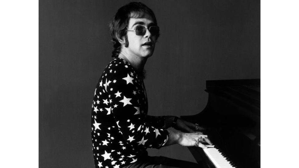 Elton John playing the piano