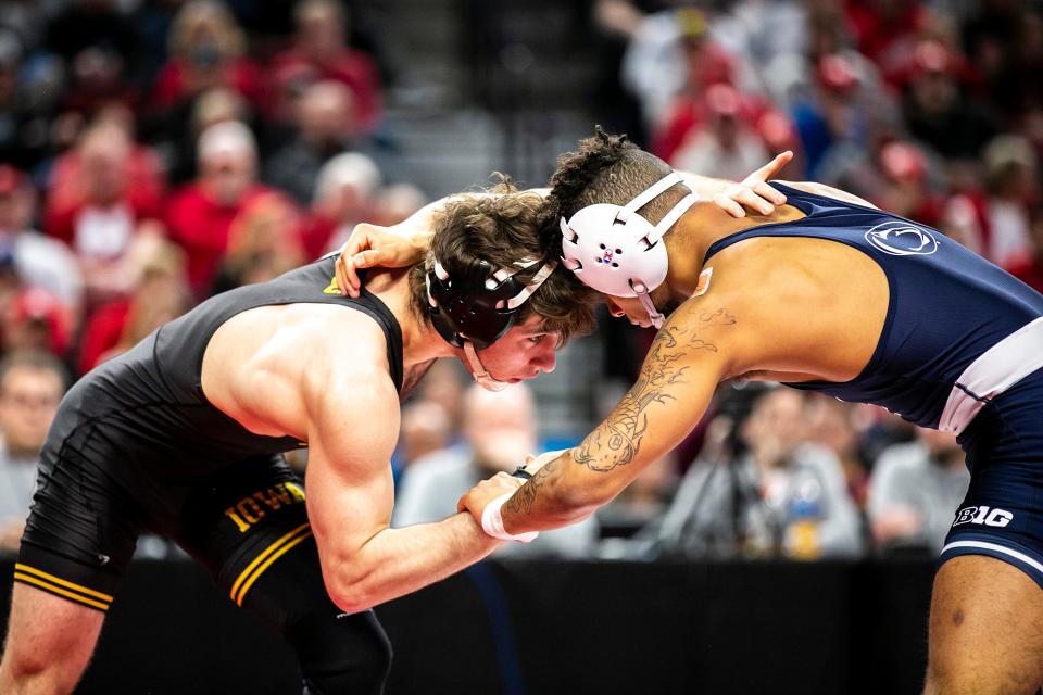 Iowa's Austin DeSanto, left, wrestles Penn State's Roman Bravo-Young at 133 pounds in the finals during the third session of the Big Ten Wrestling Championships, Sunday, March 6, 2022, at Pinnacle Bank Arena in Lincoln, Nebraska.