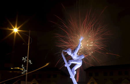 Fireworks explode behind a skiing sculpture to celebrate Beijing being chosen to host the 2022 Winter Olympics, in Chongli county of Zhangjiakou, jointly bidding to host the 2022 Winter Olympic Games with capital Beijing, July 31, 2015. REUTERS/Jason Lee