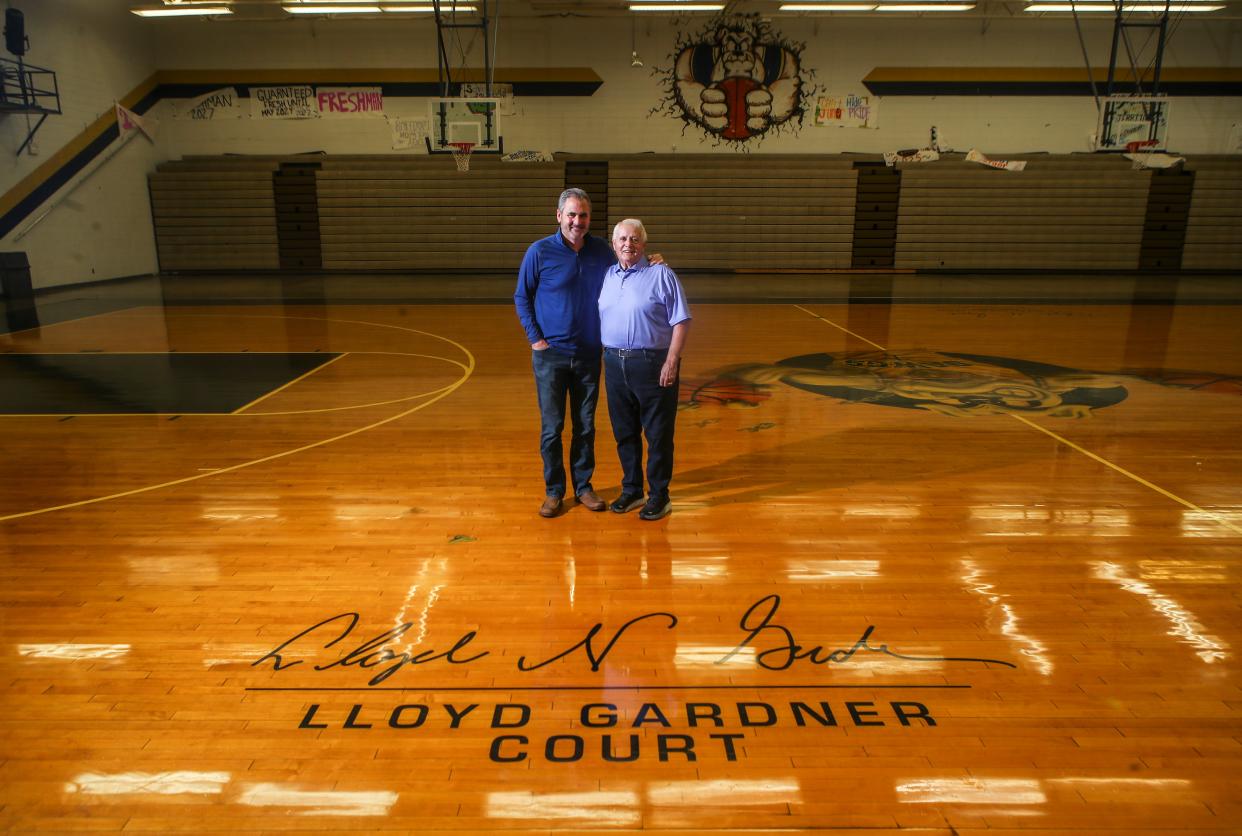 Attorney Chad Gardner and his father Lloyd Gardner inside the gym at Fairdale High School. Chad said his father had a huge influence on him growing up; his dad also coached the Bulldogs to a state championship and has the floor named after him. Oct. 12, 2023.