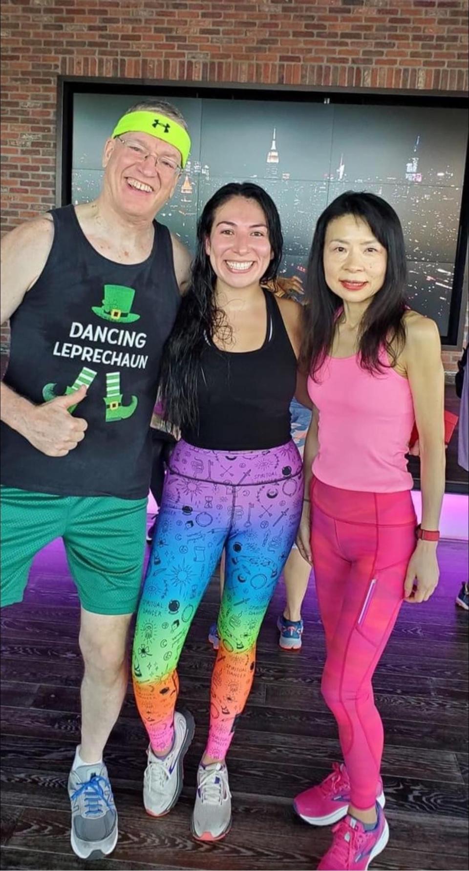 Yuko Love, right, stands with friends, Paul Stabile, left, and Maria Egan, center, after a Zumba class taught by Egan at the Newtown Athletic Club.