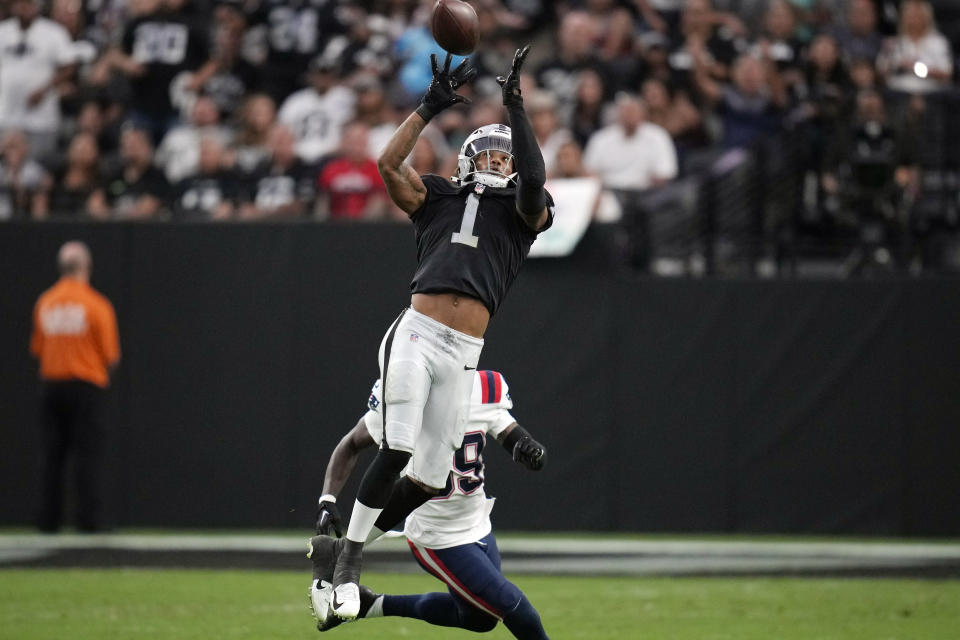 Las Vegas Raiders wide receiver Tyron Johnson (1) makes a catch during the first half of an NFL preseason football game against the New England Patriots, Friday, Aug. 26, 2022, in Las Vegas. (AP Photo/John Locher)