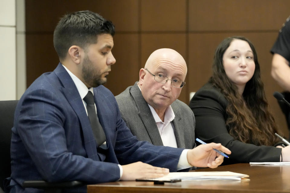 Robert E. Crimo Jr., center, father of Robert Crimo III, listens as he sits with his attorney George Gomez, left, during an appearance before Judge George D. Strickland at the Lake County, Ill., Courthouse Thursday, Jan. 26, 2023, in Waukegan, Ill. Crimo Jr., faces seven counts of felony reckless conduct for signing the application for his son's firearm owners ID card in December of 2019. (AP Photo/Nam Y. Huh, Pool)