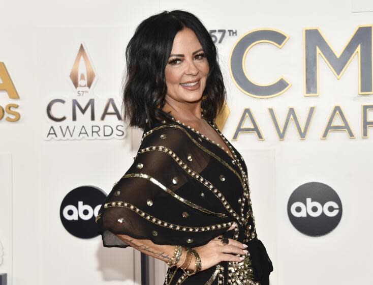 Sara Evans, in black and gold gown, at the 57th Annual CMA Awards in Nashville, Tenn.