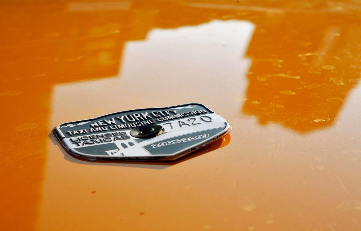 A taxi medallion seen on a parked taxi in New York